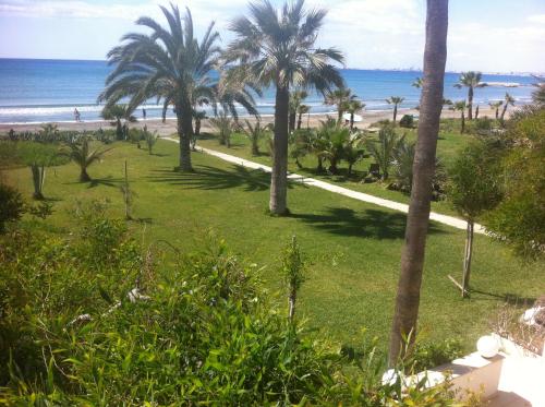 a view of the beach from the balcony of a resort at Sandy Beach Apartment 13 in Voroklini