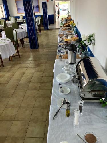 a buffet line with food on a table in a restaurant at THE FOZ Beach Hotel in Figueira da Foz