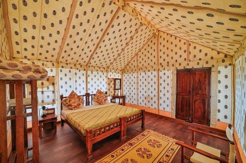 a bedroom with a bed in a room at Jaisalmer Winds Desert Camp in Jaisalmer