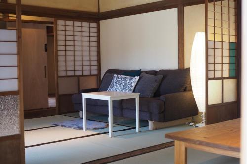 a living room with a couch and a table at 岡邸 in Tonosho