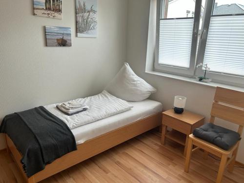 Zimmer mit einem Bett mit einem Kissen und einem Fenster in der Unterkunft Tempel-Inn Konrad-Adenauer-Straße 4 in Werlte