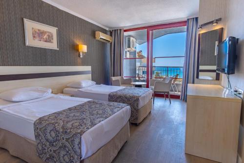 a hotel room with two beds and a balcony at A11 Hotel Obaköy in Alanya