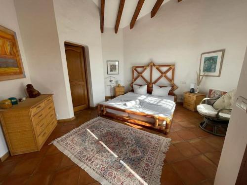 a bedroom with a bed and a couch in it at Spacious Villa with Pool and Fireplace in Roquebrune-sur-Argens