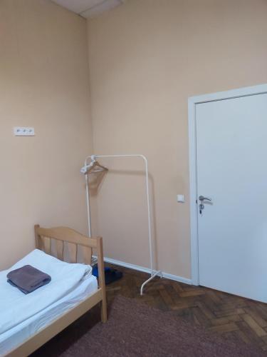 a small room with a bed and a glass door at Hostel Best time in Lviv