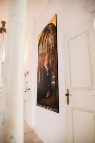 a hallway with a painting on the wall and a door at Elephant in my room in Dubrovnik
