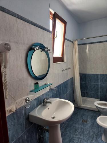 a bathroom with a sink and a mirror at Guesthouse Bimbli in Pogradec