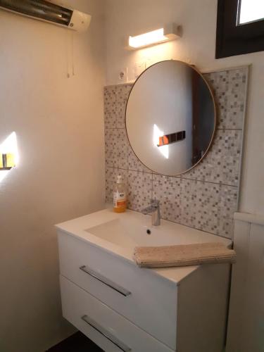 a bathroom with a sink and a mirror at n6 appartement de Vacancorse Maison U Canale in Speloncato