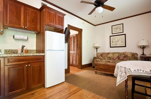 a kitchen with a white refrigerator and a couch at Island City House in Key West