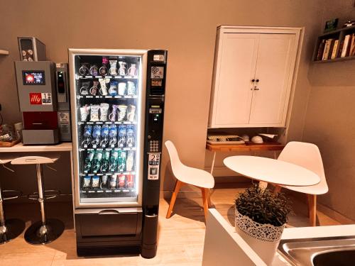 a refrigerator filled with lots of drinks in a kitchen at Fabio Massimo Guest House in Rome