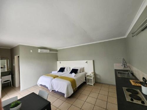 a bedroom with a large bed in a room at Noordoewer Self Catering Chalets in Noordoewer