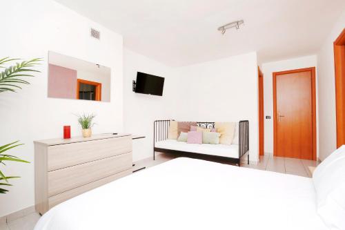 a living room with a couch and a tv at Appartamenti Diffusi di Villa Fiorita con accesso alle PISCINE della struttura principale in Cattolica