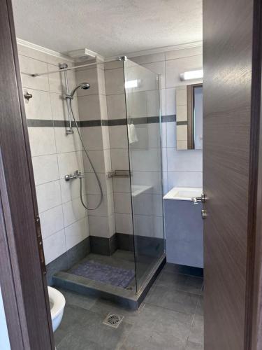 a bathroom with a shower with a toilet and a sink at Brand new studio Sea View in Agia Pelagia
