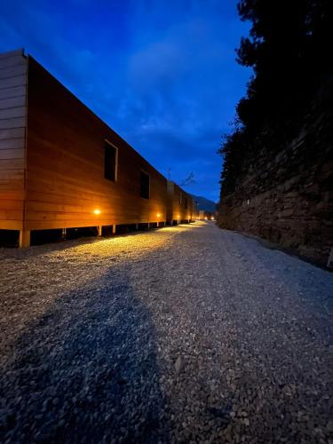 a long building on a gravel road at night at Lakeview Cannobio Camping & Resort in Cannobio