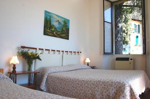 ブルナーテにあるB&B ヴィラ ミランドーラのベッドルーム1室(ベッド2台付)が備わります。壁に絵が描かれています。