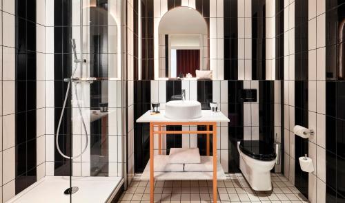 a bathroom with a sink and a toilet at Mama Shelter Rennes in Rennes