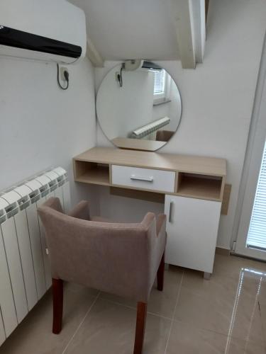 a dressing table with a mirror and a chair at Villa Jankuloski in Ohrid