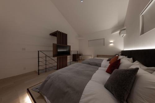 Katil atau katil-katil dalam bilik di Condominium ISHITEI Furano