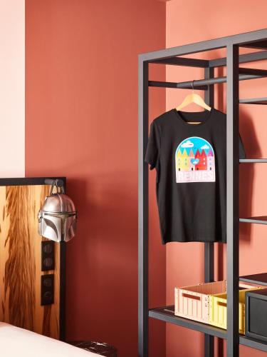 a black t shirt on a rack in a room at Mama Shelter Rennes in Rennes