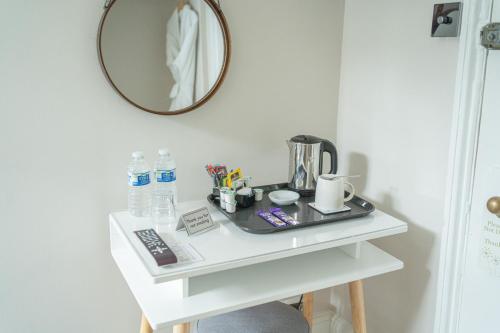 a white table with a mirror on top of it at INNit Marina in Brighton & Hove