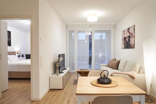 a living room with a couch and a table at Wohnen auf Zeit & Ferien in Wehr - Apartment Sand in Wehr