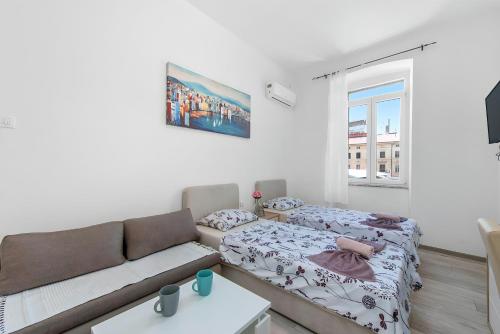 a living room with a couch and a bed at Market & Art square place in Rijeka