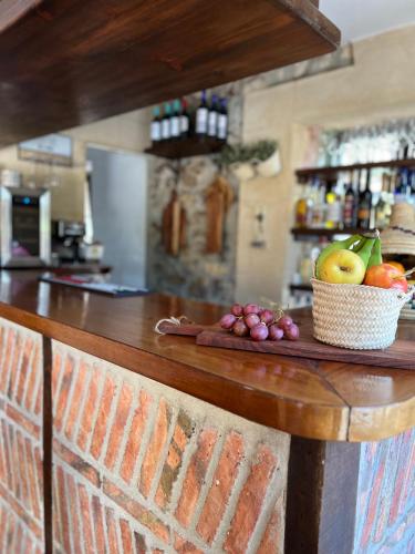 a counter with a bowl of fruit on it at Posada La Fontana in Santillana del Mar