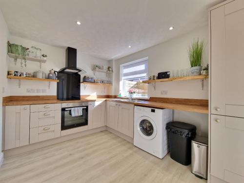 a kitchen with a washer and dryer in it at DYSA Bentinck House in Blackpool