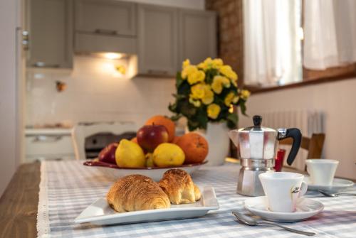 a table with two plates of bread and fruit on it at Acquamarina in Spello