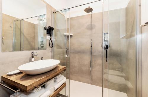 a bathroom with a sink and a shower at Acquamarina in Spello