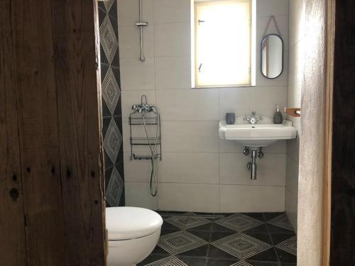 a bathroom with a toilet and a sink at Village farm house Nazri 