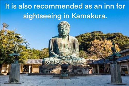 a statue of a buddha sitting in a park at 平野邸 Hayama in Hayama
