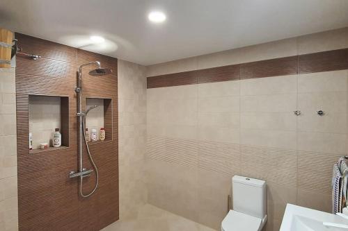 a bathroom with a shower and a toilet and a sink at Villa “Nadezhda” in Tsareva Livada