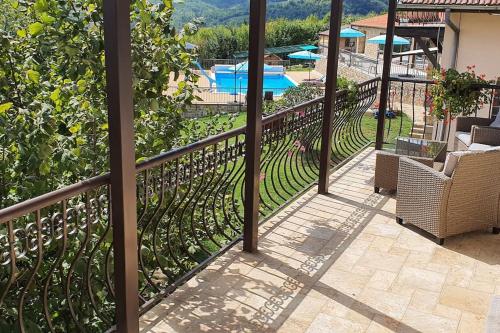 a balcony with a fence and a swimming pool at Villa “Nadezhda” in Tsareva Livada