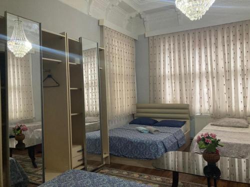 a bedroom with two beds and a mirror at Üsküdar Villa in a Great Location in Istanbul