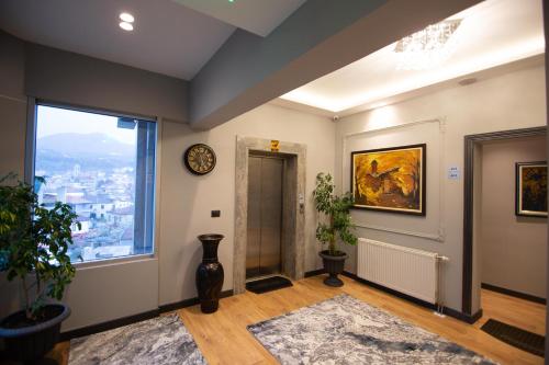 a hallway with a window and a clock on the wall at Sky Hotel Korce in Korçë
