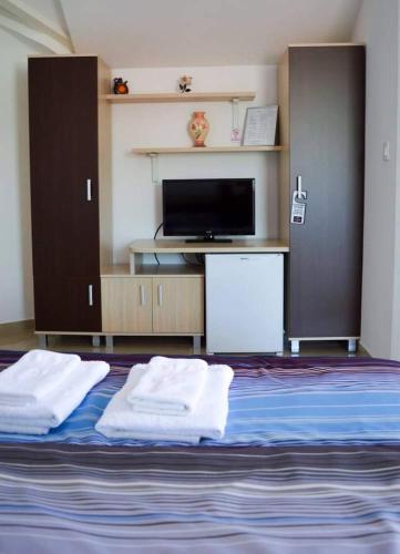 a bedroom with a bed with two white towels on it at Villa Jankuloski in Ohrid