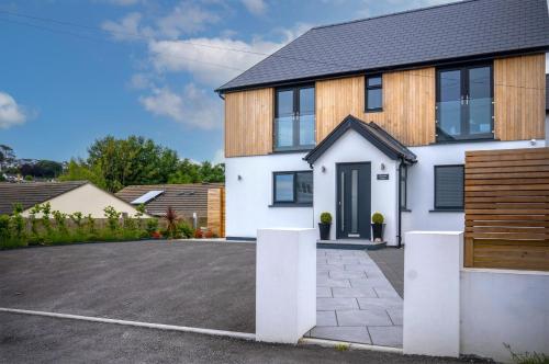 a house with a driveway in front of it at Gower View - 4 Bedroom Luxurious Holiday Home - Saundersfoot in Saundersfoot
