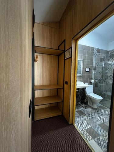 a bathroom with a toilet and a sink at Vila M 36 in Topliţa