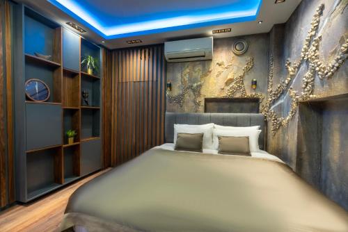 a bedroom with a large bed and a wall at 6 Apartment Galata in Istanbul