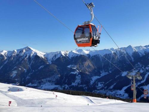 a ski lift flying over a snow covered mountain at Haus Breitenfellner by AlpenTravel in Bad Hofgastein