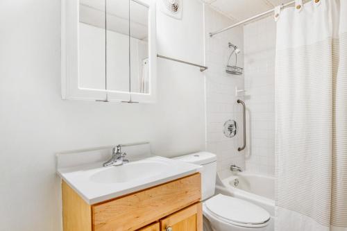 a white bathroom with a sink and a toilet at Central Sq 2BR nr Central Sq T stop BOS-570 in Cambridge