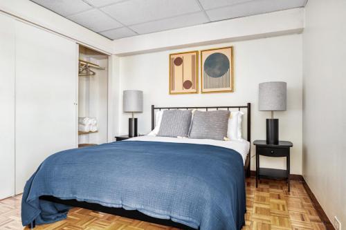 a bedroom with a large bed with a blue blanket at Central Sq 2BR nr Central Sq T stop BOS-570 in Cambridge
