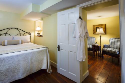 a bedroom with a white bed and a door at Eliza Thompson House, Historic Inns of Savannah Collection in Savannah