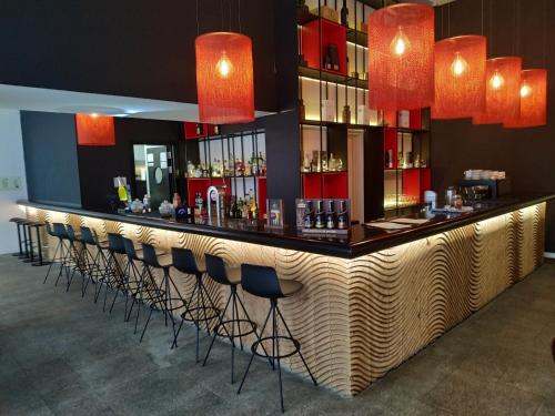 a bar with a row of bar stools at Hotel Carris Porto Ribeira in Porto