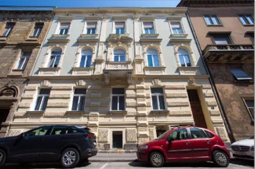 two cars parked in front of a building at Apartments Zagreb1875 in Zagreb