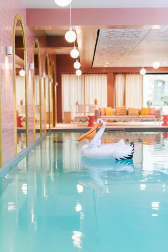 a pool with a swan float in the water at Mama Shelter Rennes in Rennes