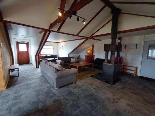 a living room with a couch and a fireplace at Abrahams Camp in Flisehult