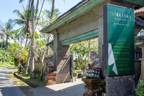 two statues of monkeys in front of a building at Starloka Saba Bali Hotel in Blahbatu