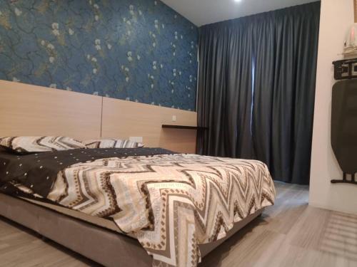 a bedroom with a bed with a painting on the wall at Muslim Homestay blue Adik Aisyah Apartment in Tanah Rata