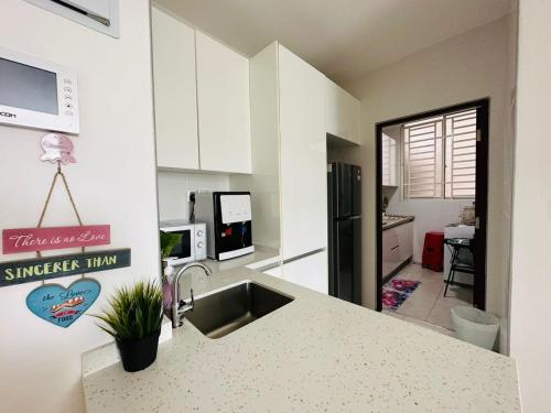 a kitchen with a sink and a counter top at Paragon Residence 8-12pax-Big Balcony with BBQ in Johor Bahru